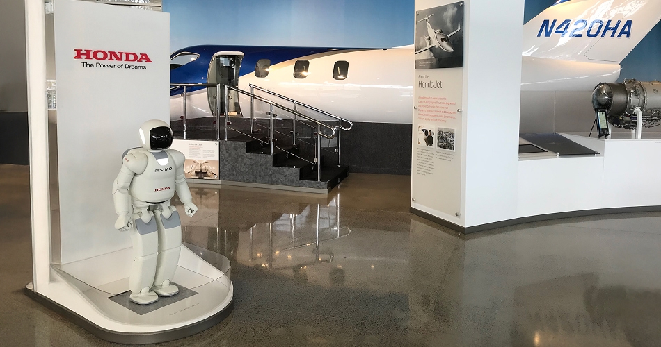 An Asimo humanoid robot and a HondaJet model in The Honda Heritage Center.